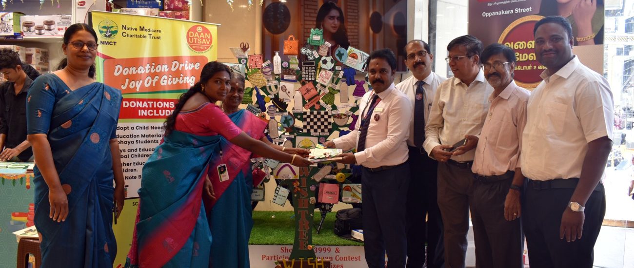 NMCT staff and supporters beside the Wish Tree at the Daan Utsav donation drive