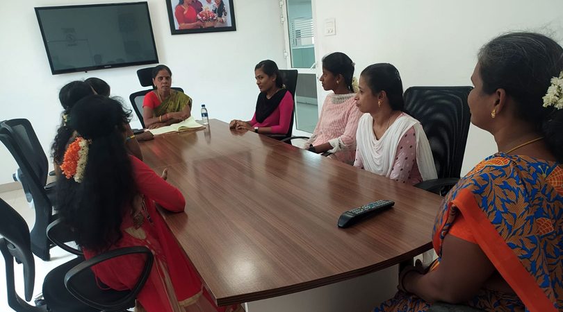 Women employees meeting around a table during an NMCT Internal Committee session